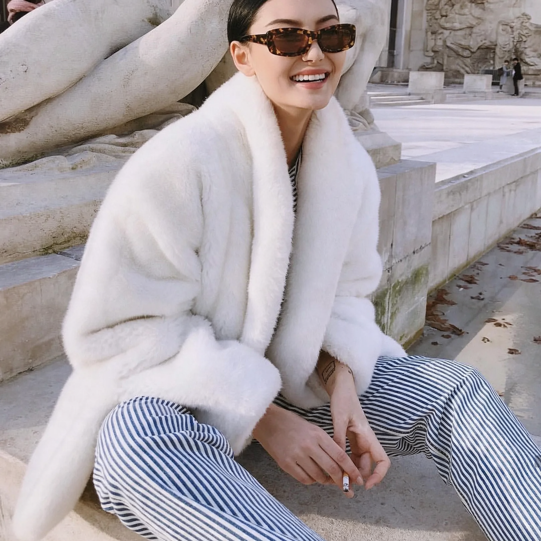 Elegant women's faux fur coat, fluffy