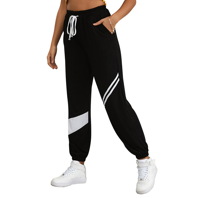 Women's sporty jogging pants with elastic waistband and contrast stripes Chichicherry