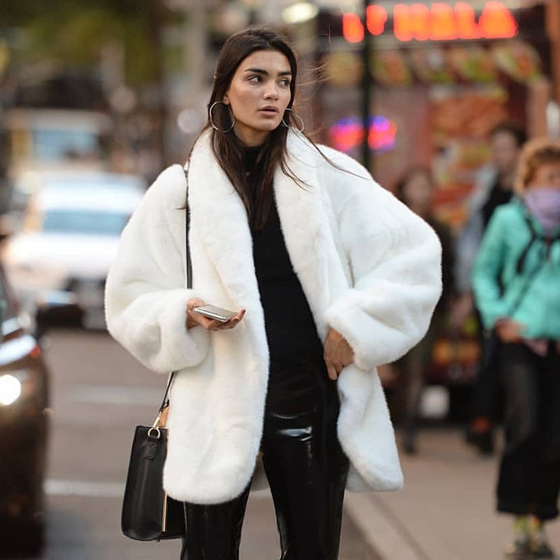Elegant women's faux fur coat, fluffy