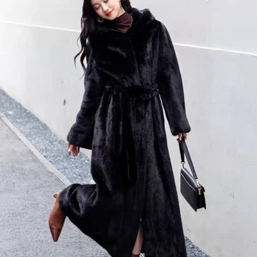 Long women's coat made of faux fur with hood