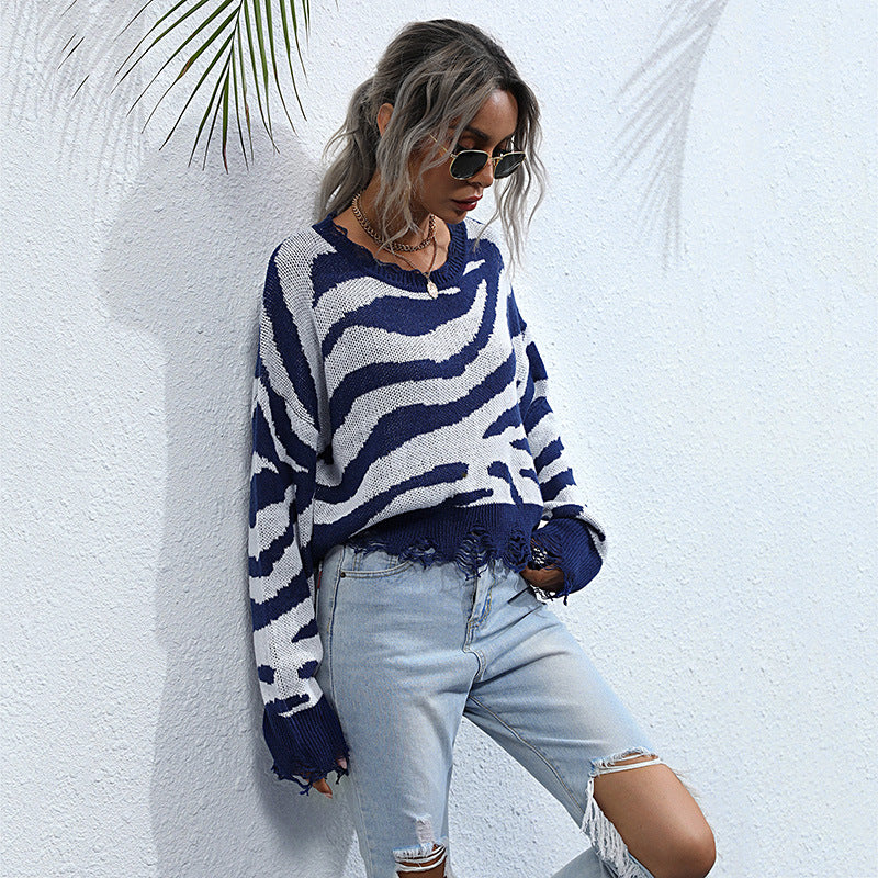Women’s oversized knit sweater with zebra stripe jacquard, frayed hem, and raglan sleeves Chichicherry