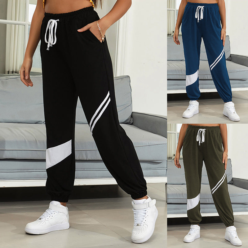 Women's sporty jogging pants with elastic waistband and contrast stripes Chichicherry