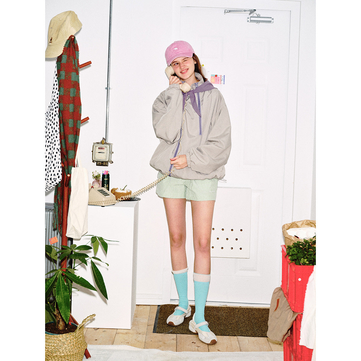 Unisex short cut technical windbreaker with asymmetric two-way zipper, detachable storm hood and shoulder mini bag Chichicherry