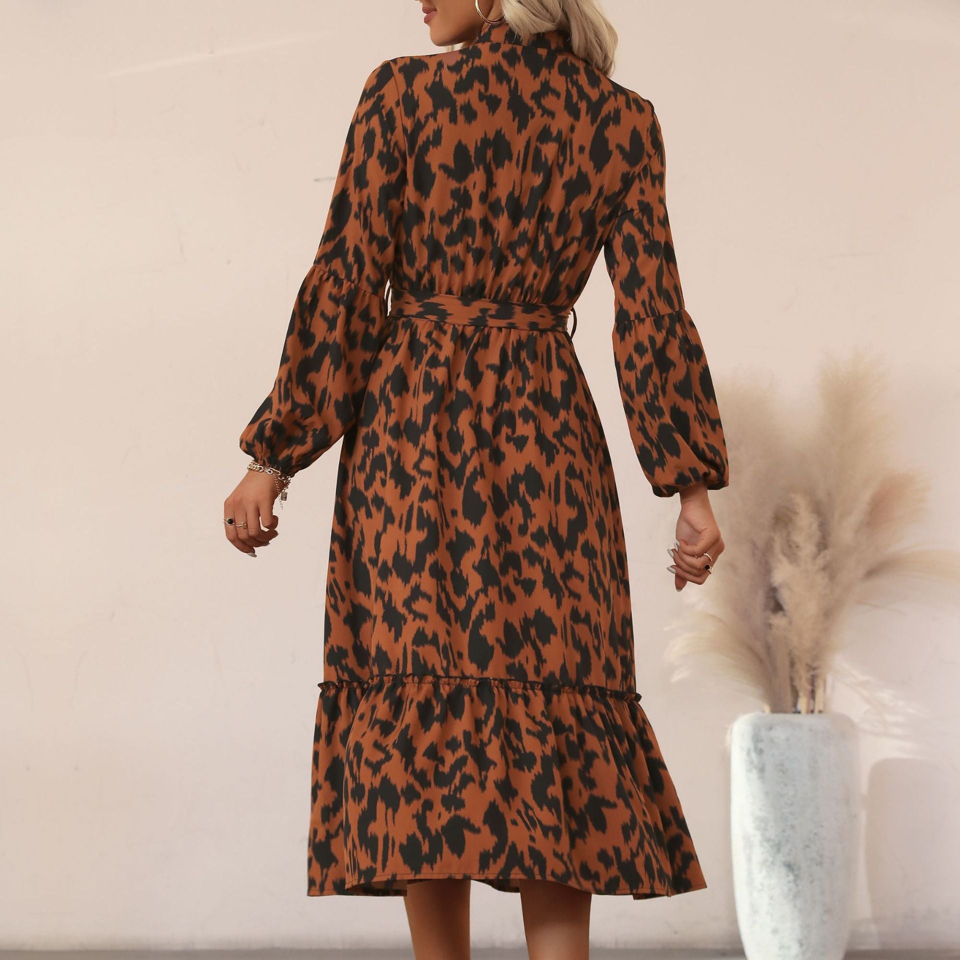 Women's viscose midi dress with leopard print, concealed button placket, waistband, and tiered ruffles.