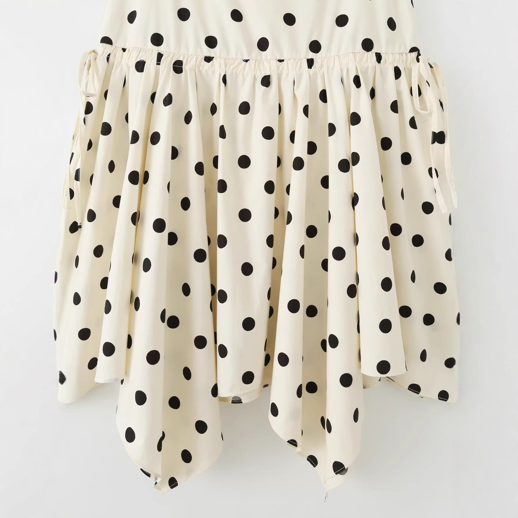 Women's midi skirt with asymmetrical jagged hem, polka dot pattern and high waistband Chichicherry