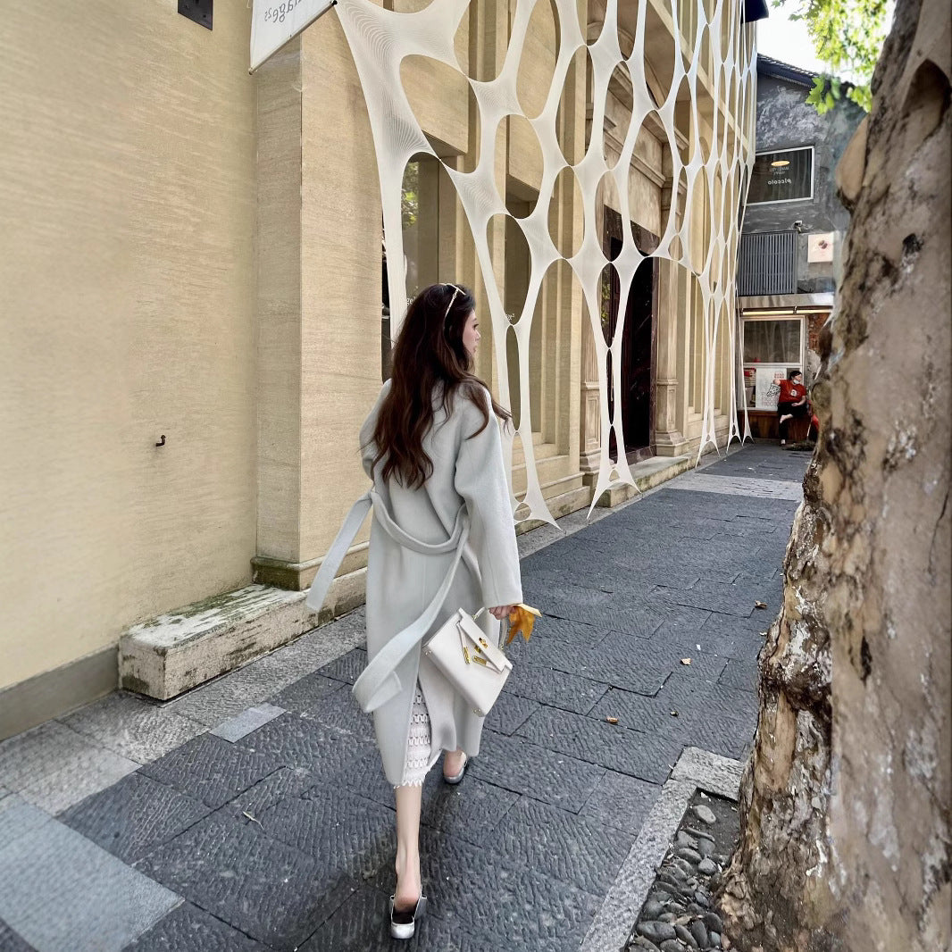 Women’s wool coat with double-breasted button placket, waist belt, and stand-up collar Chichicherry