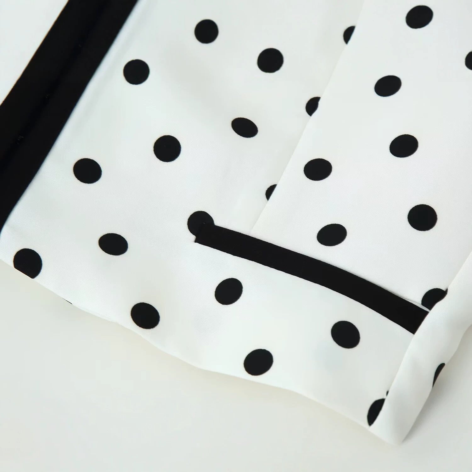 Women's short blazer in polka dot design with black contrast piping and round neck Chichicherry