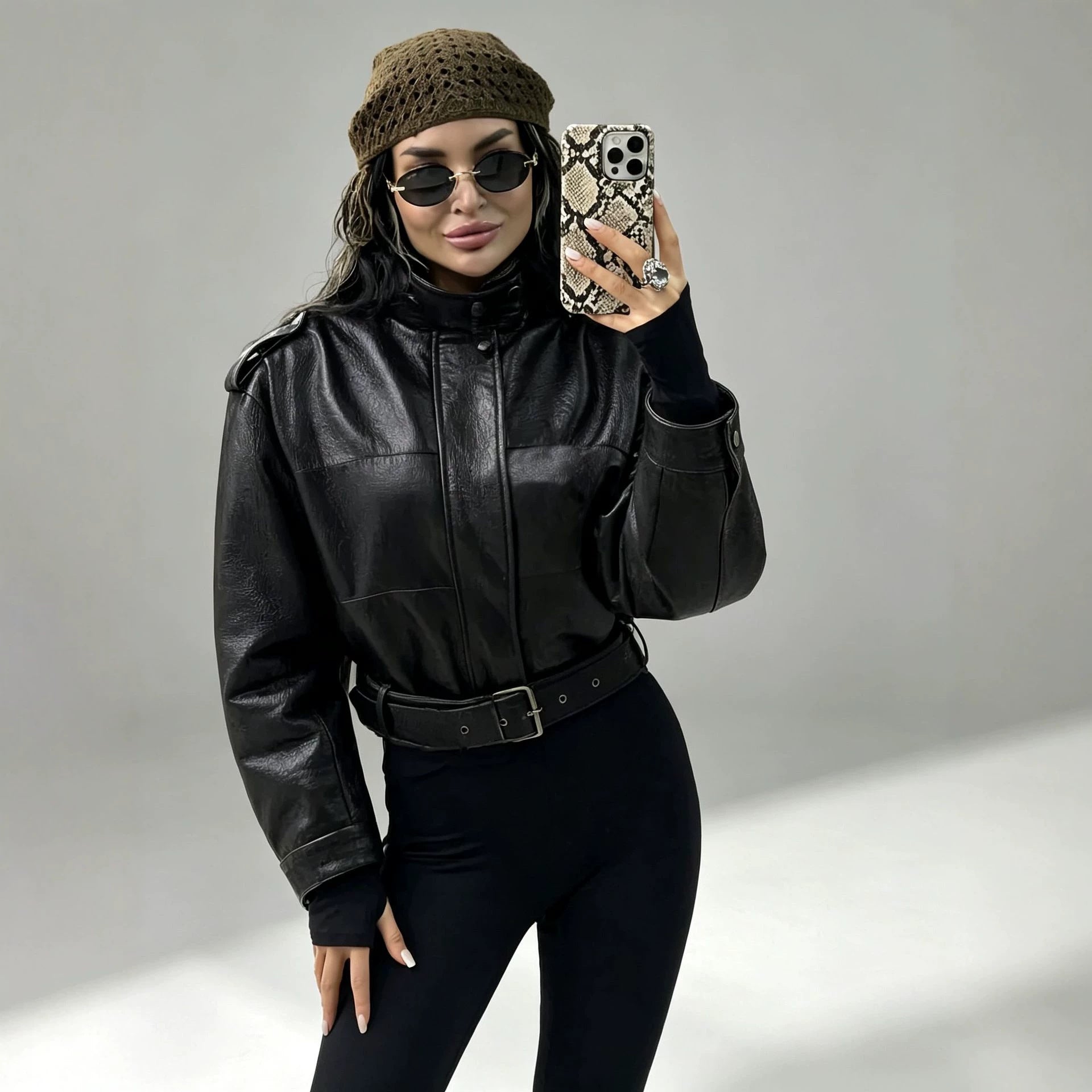 Women's short jacket in utility look made of structured faux leather with high stand-up collar and adjustable waist belt Chichicherry