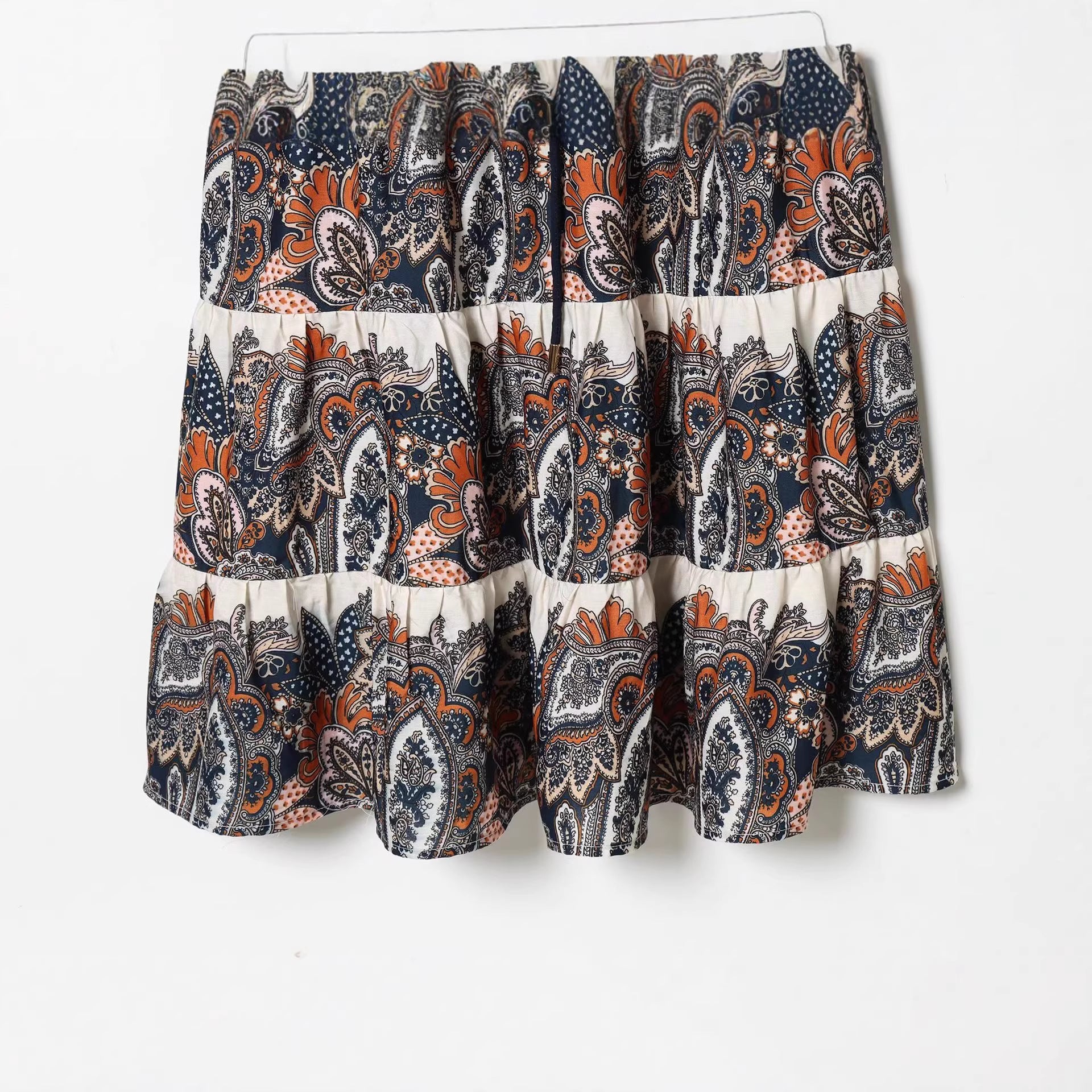 Women's maxi dress in tiered skirt design with paisley print, stand collar, and waist drawstring Chichicherry