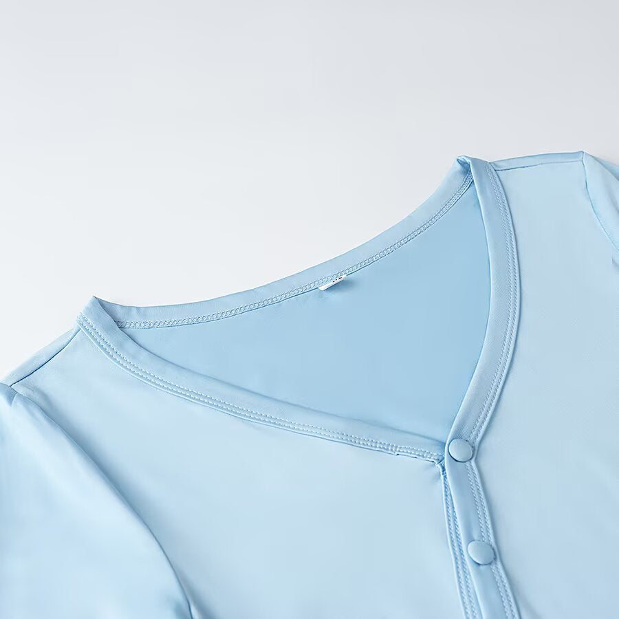 Women's wrap blouse with asymmetrical button placket, gathered hem, and trumpet sleeves Chichicherry
