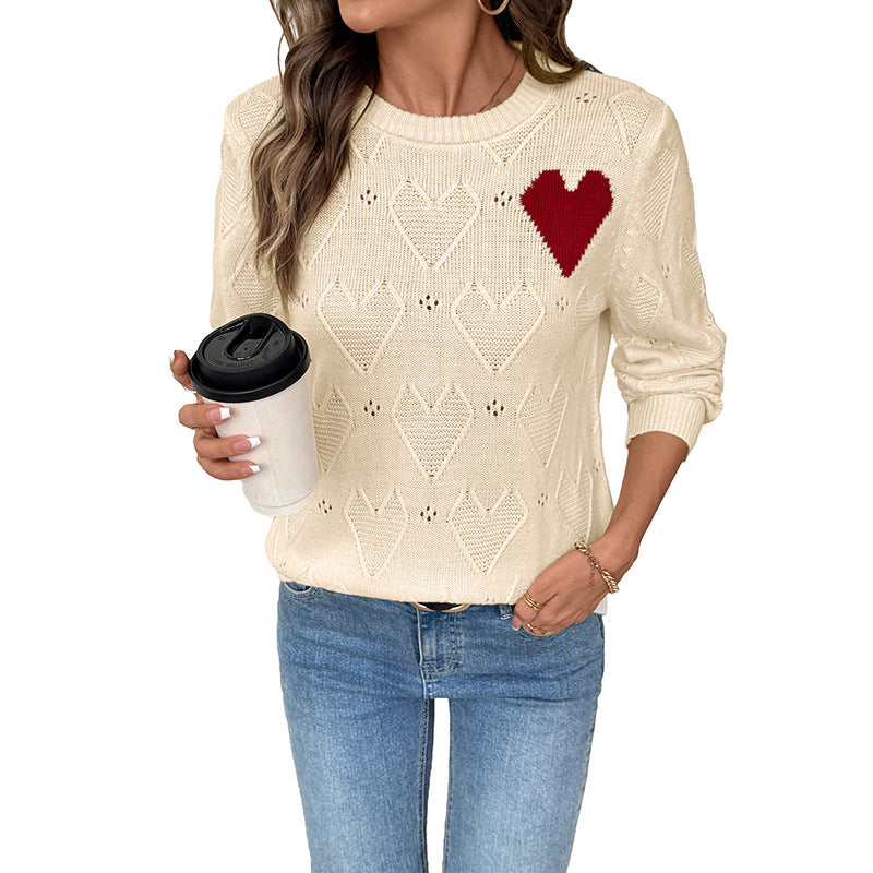 Women's fine knit sweater with openwork heart pattern, applied decorative heart and round neckline