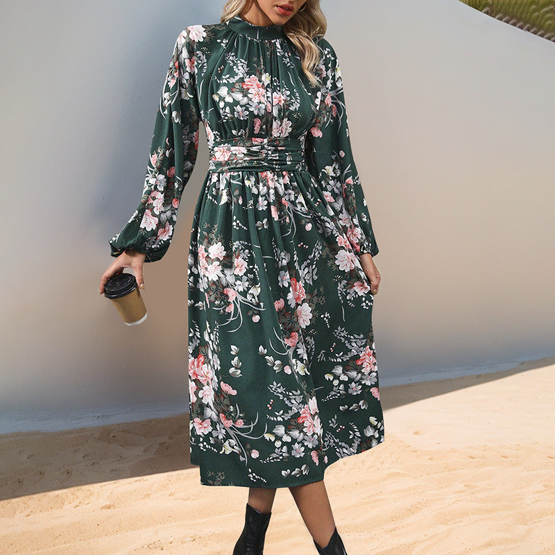 Women's midi dress with floral all-over print, stand collar and draped waist belt.