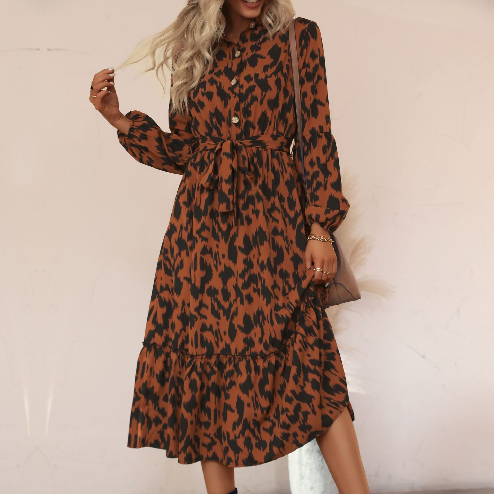 Women's viscose midi dress with leopard print, concealed button placket, waistband, and tiered ruffles.