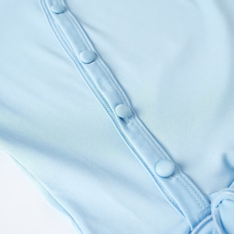 Women's wrap blouse with asymmetrical button placket, gathered hem, and trumpet sleeves Chichicherry