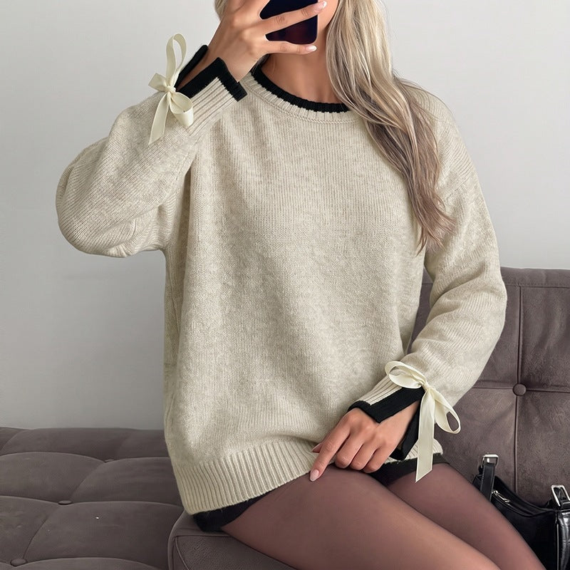 Women's oversized fine knit pullover with contrast ribbed yoke and bow details