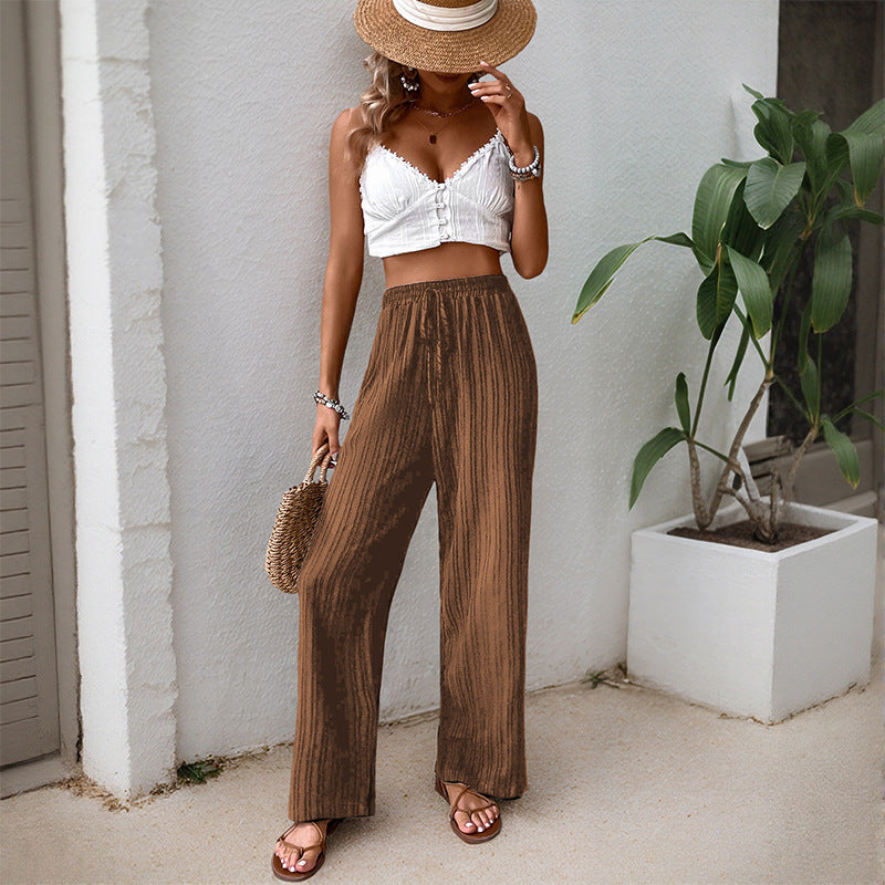 Women's loose summer trousers made from lightweight crinkle fabric with elastic waistband and drawstring.
