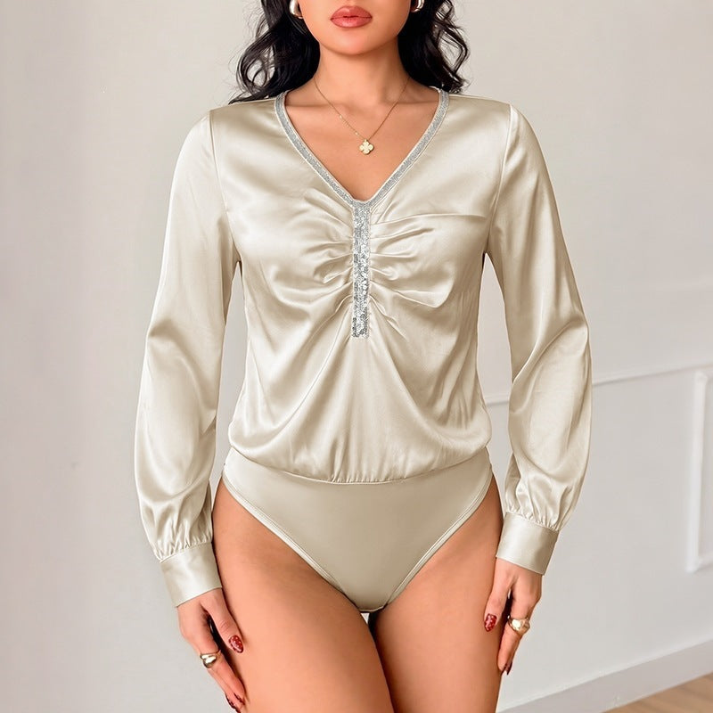 Women's satin blouse with V-neck, gathered front section and decorative ribbon.