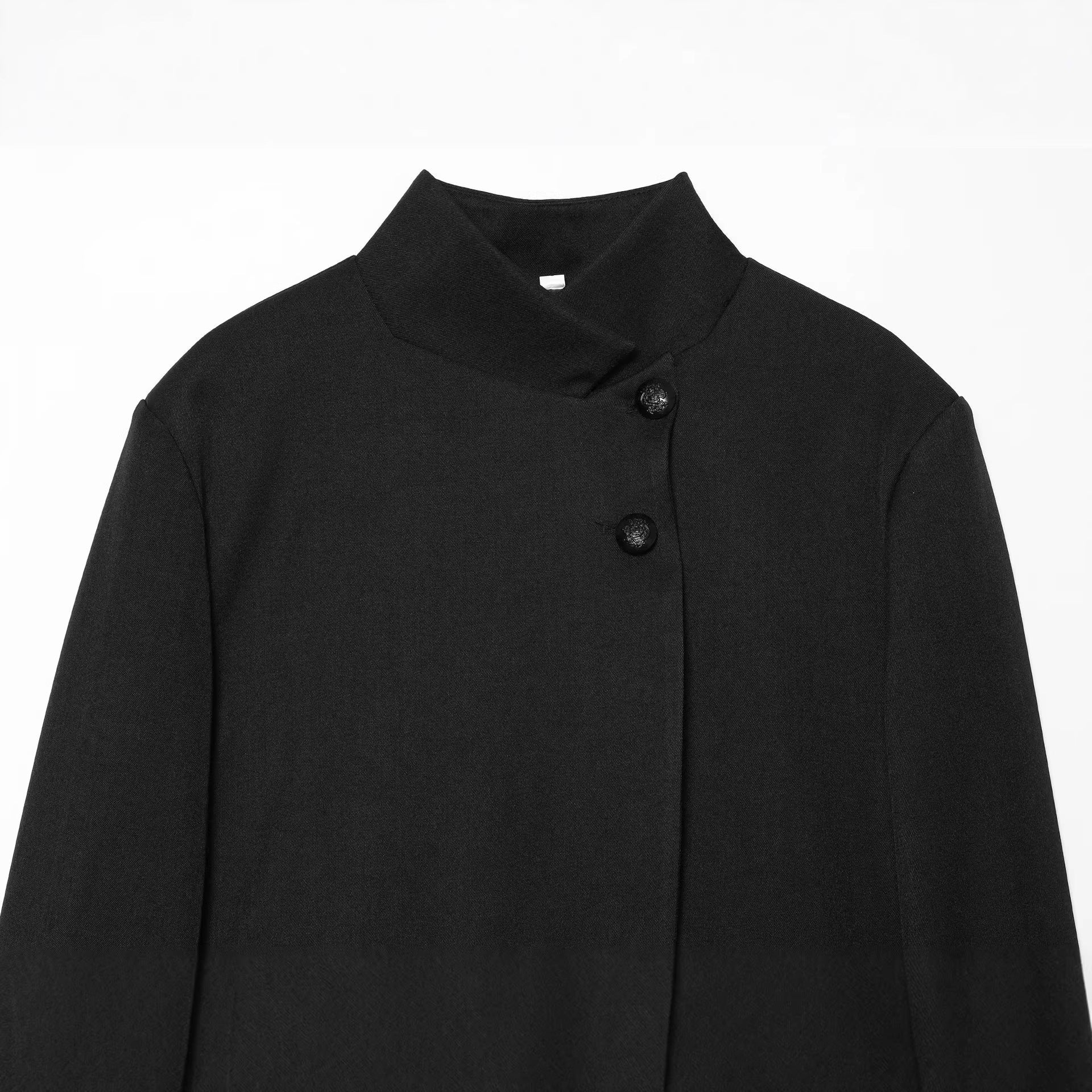 Women’s short-cut blazer with stand-up collar, asymmetrical closure, and piping pockets Chichicherry