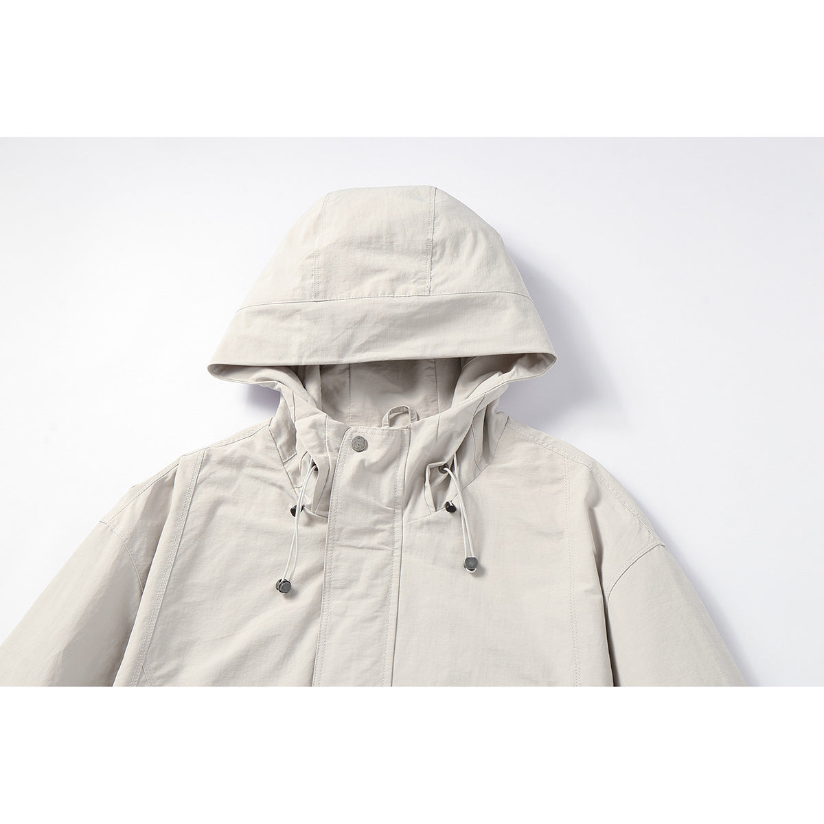 Unisex Light windproof hooded jacket in boxy cut with drawstring and concealed front Chichicherry
