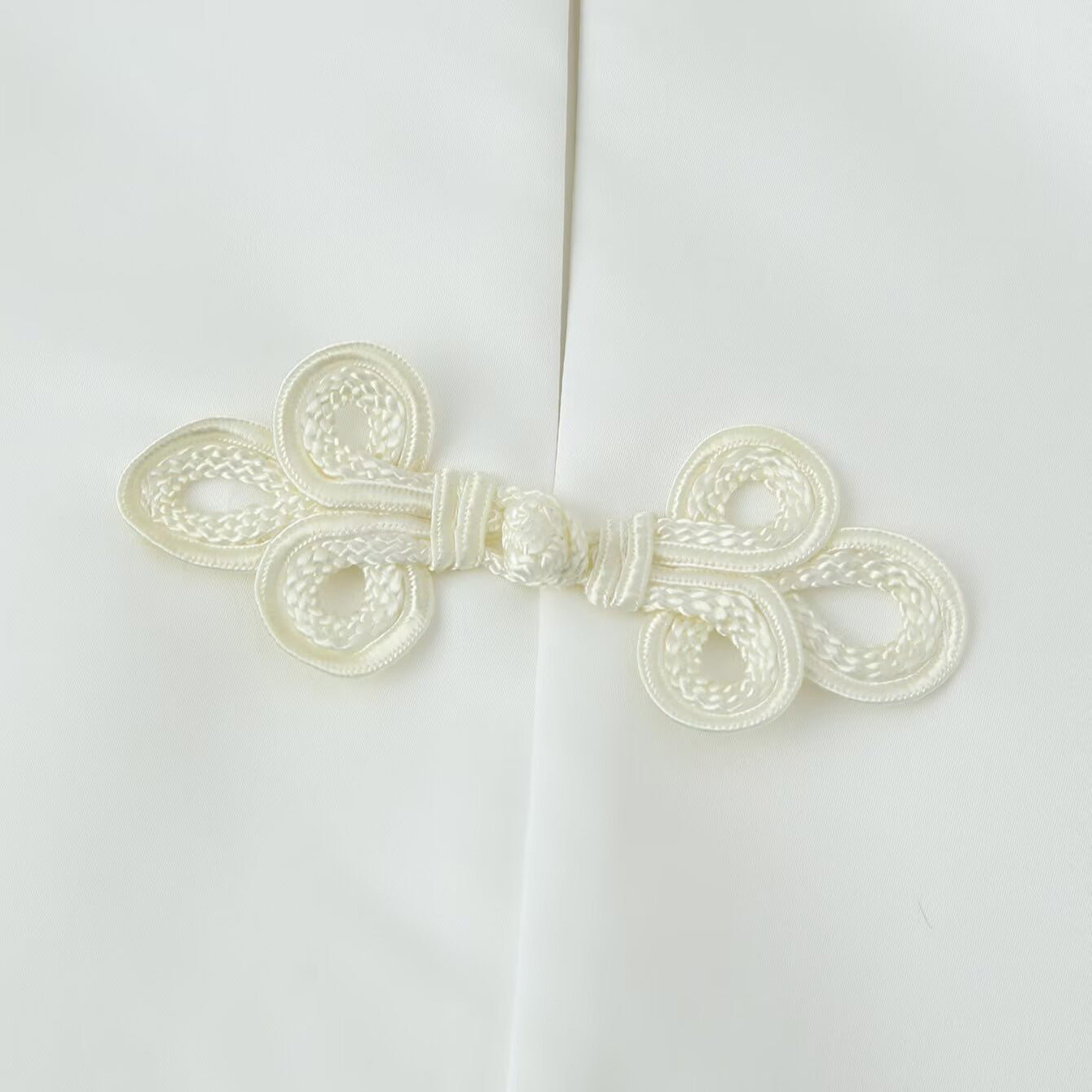 Women's short jacket with stand collar and decorative knot closures Chichicherry