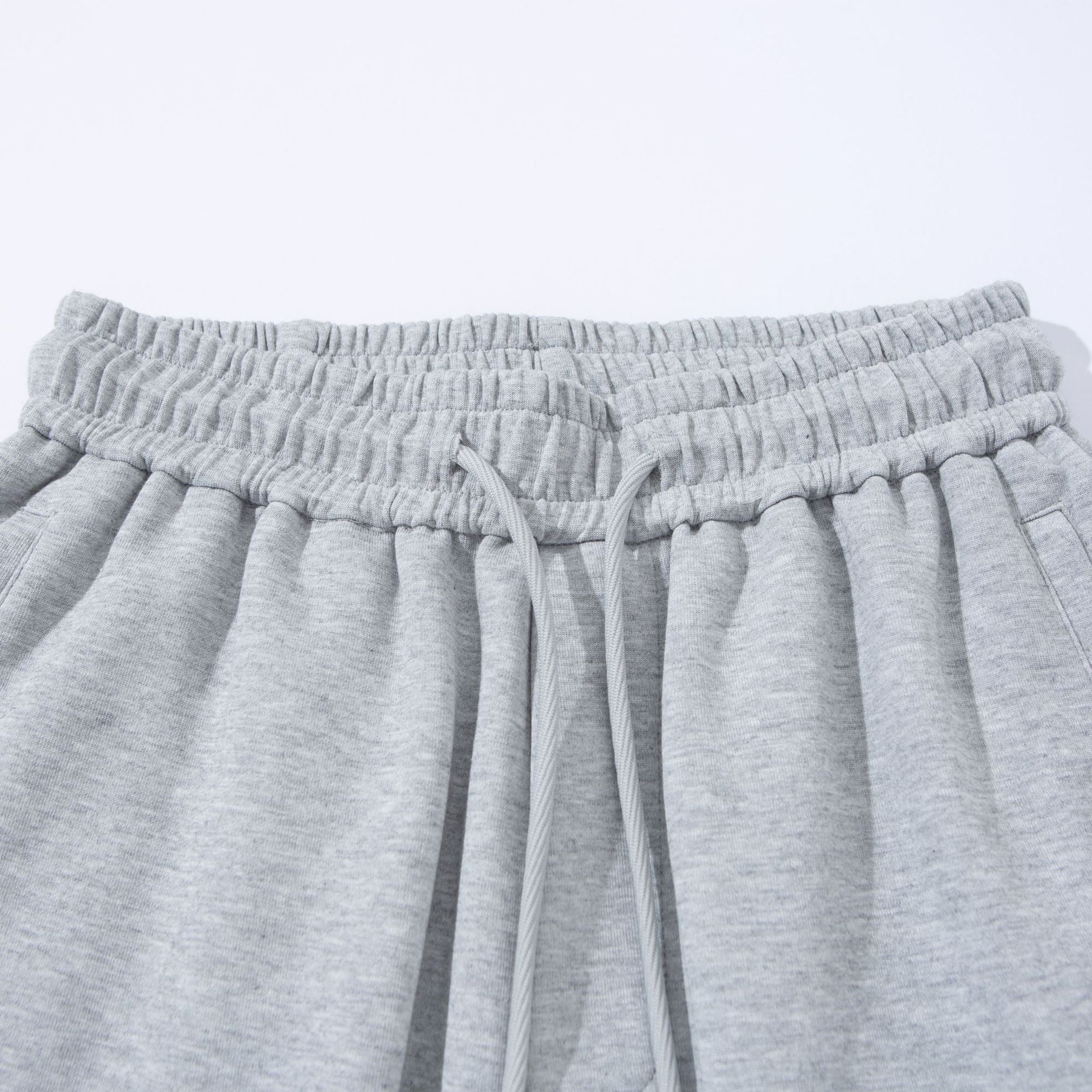 Unisex Wide French-Terry Sweatpants with elastic drawstring waistband, side pockets, and adjustable hem.
