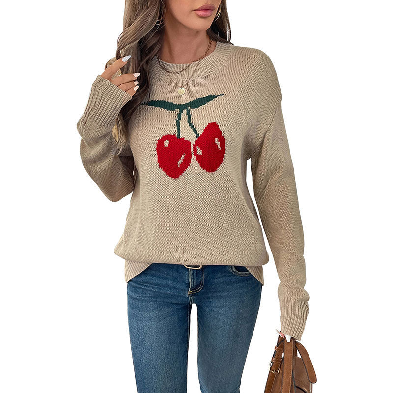 Women's oversized knit sweater with cherry intarsia, lightly distressed look and round neck.