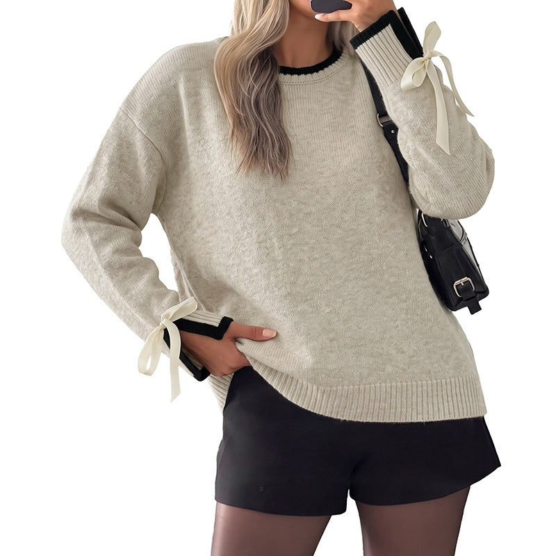 Women's oversized fine knit pullover with contrast ribbed yoke and bow details