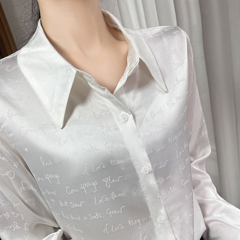 Women’s satin blouse with delicate jacquard writing, pointed shirt collar and continuous button closure Chichicherry