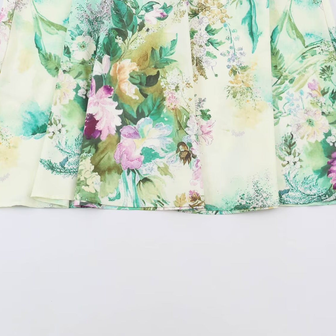 Women’s midi dress with pleated bodice, bell sleeves, and floral A-line skirt