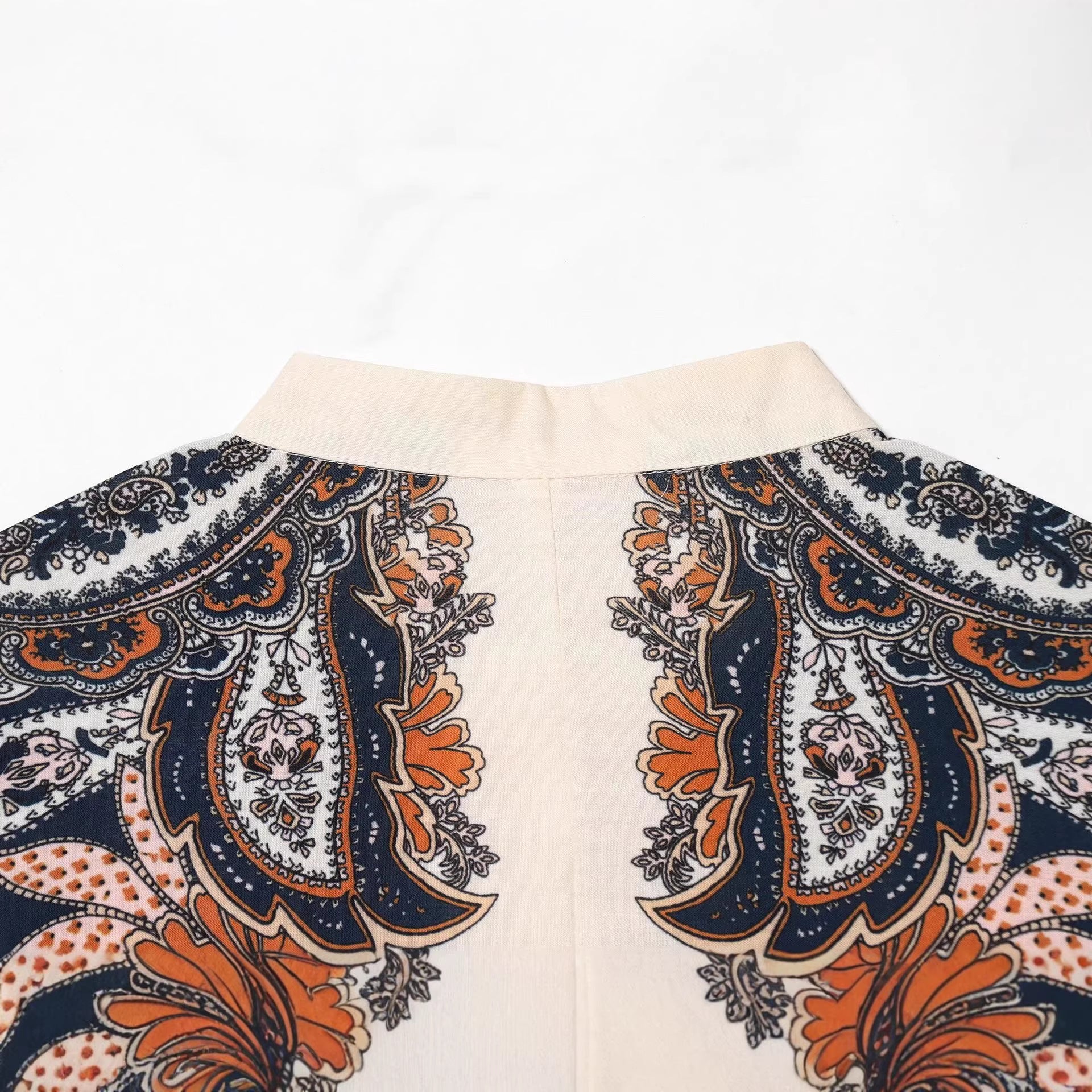 Women's maxi dress in tiered skirt design with paisley print, stand collar, and waist drawstring Chichicherry