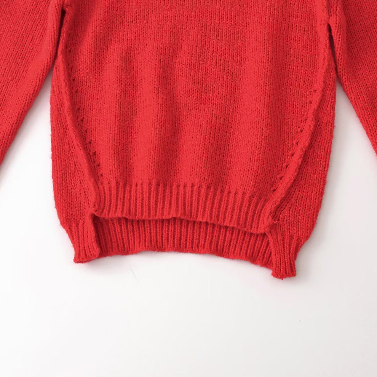 Women’s chunky knit oversized pullover with short stand-up collar and decorative knot detail