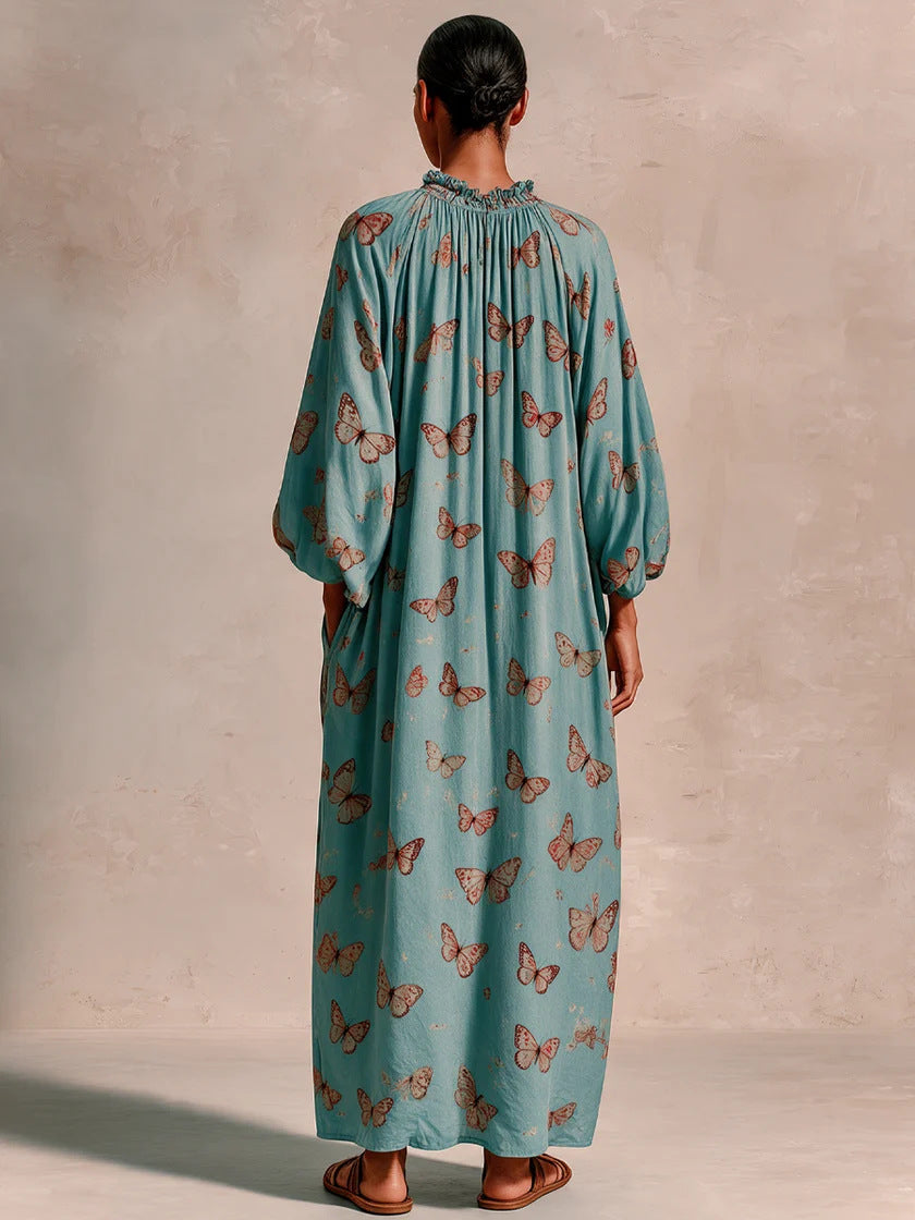 Women’s maxi dress in boho caftan style with butterfly print and gathered empire waist drape