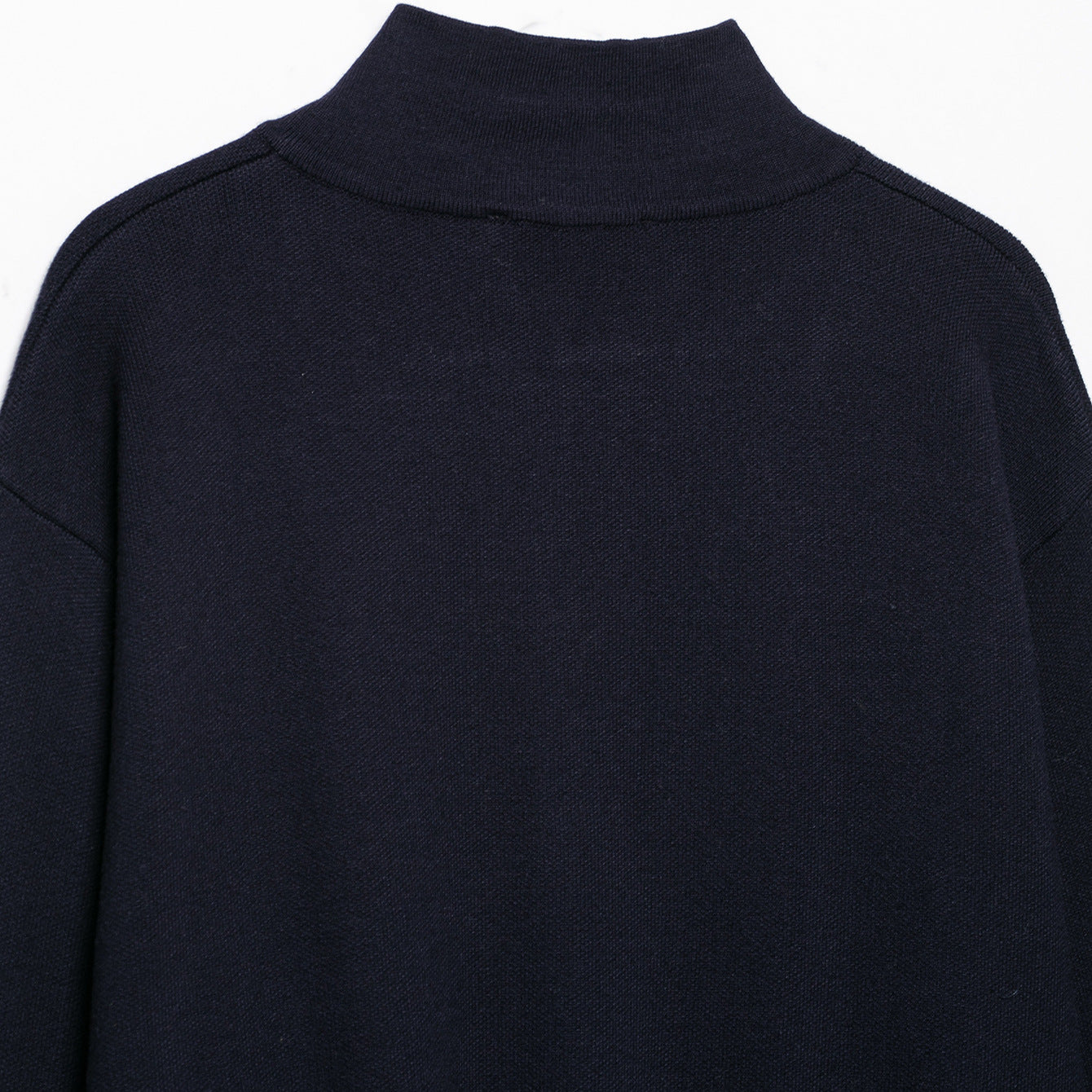 Women's cropped fine-knit cardigan with standing collar, full-length zipper, and fitted ribbed section.