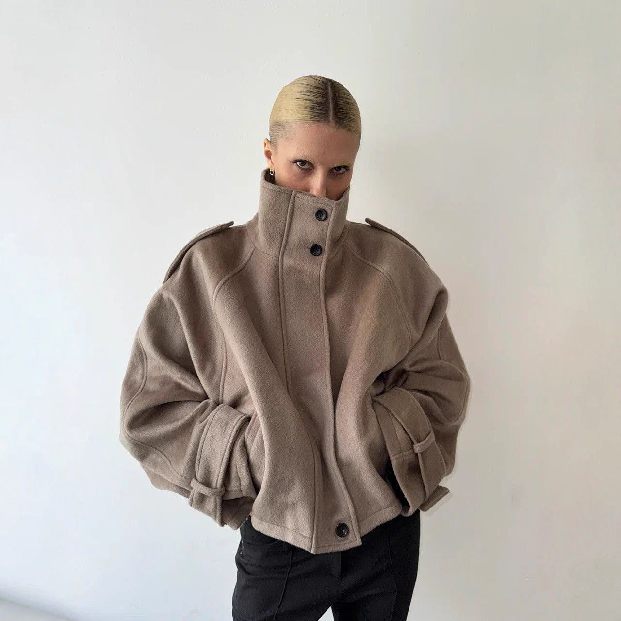 Ladies short cut oversized wool jacket with high stand-up collar, shoulder flaps and adjustable sleeve straps Chichicherry