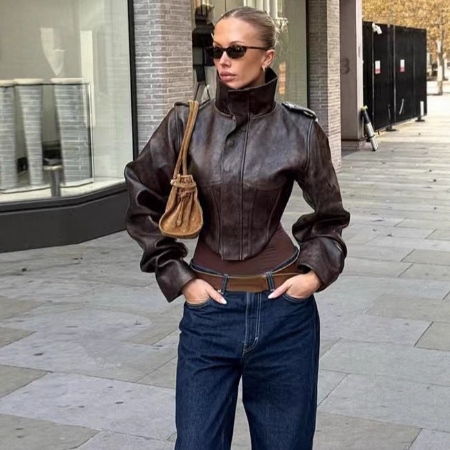 Women's short jacket made of faux leather with a high stand-up collar, shoulder flaps, and tailored silhouette Chichicherry