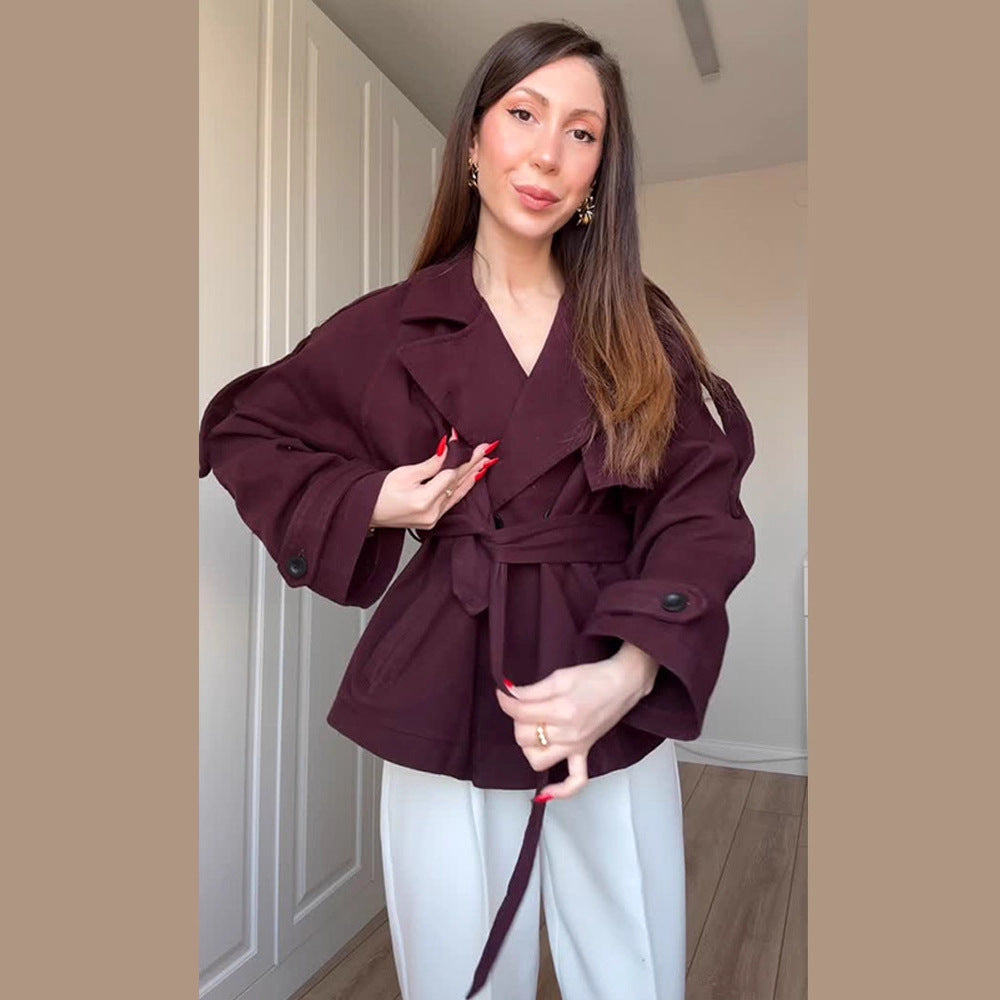 Women's short trench-style jacket with belted waist, oversized sleeves, and boxy cropped silhouette Chichicherry