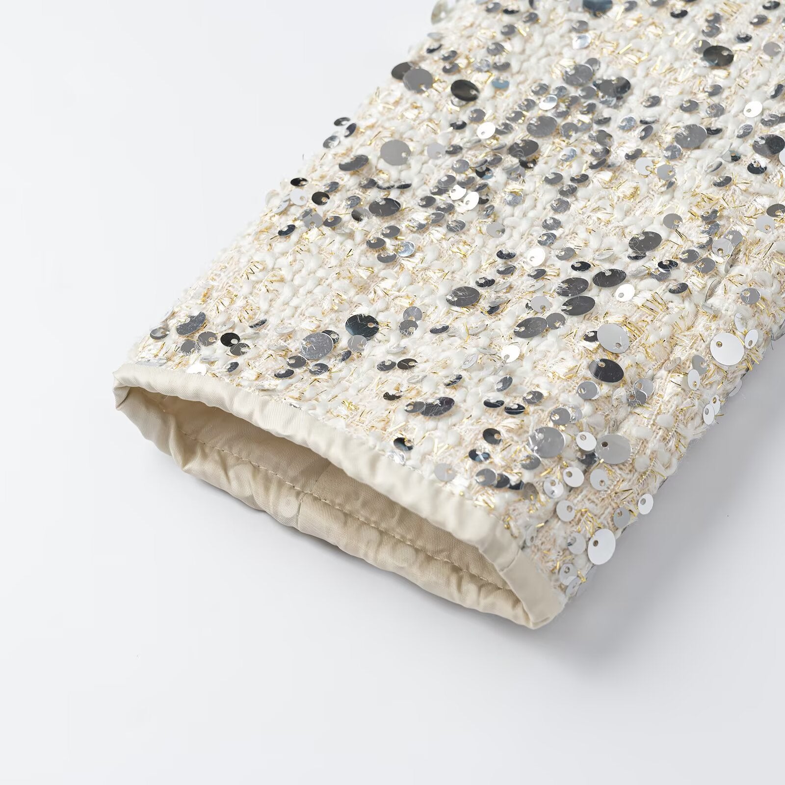 Women's short jacket made of bouclé with sequin trim, decorative pearl buttons, and a belted waist Chichicherry