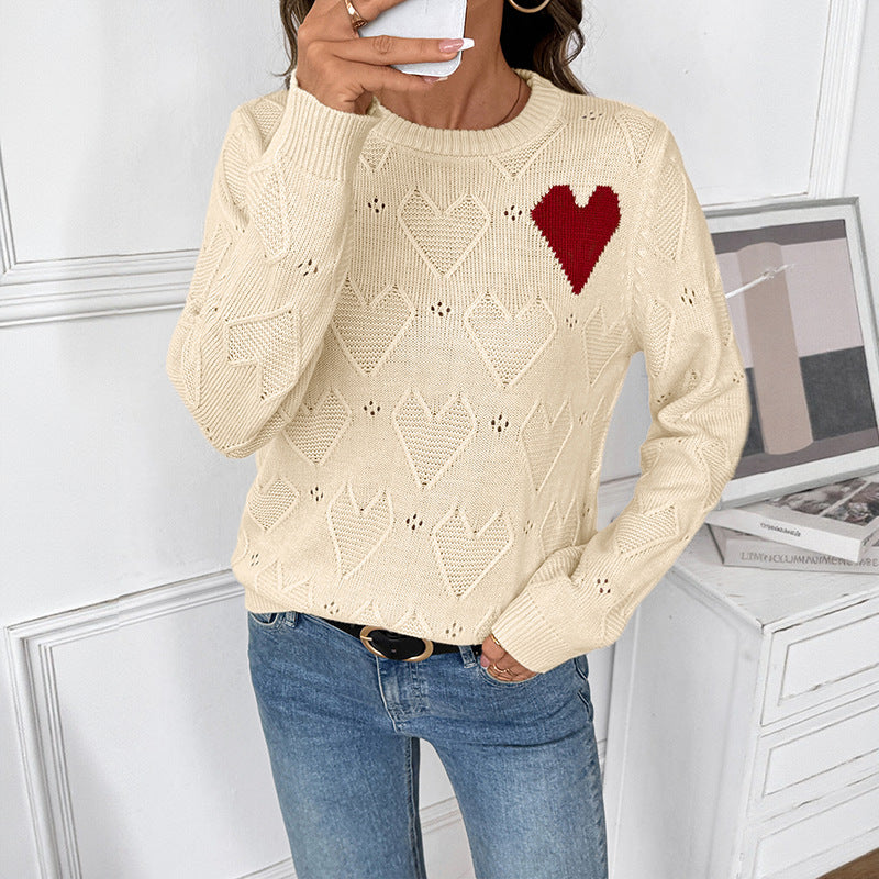 Women's fine knit sweater with openwork heart pattern, applied decorative heart and round neckline