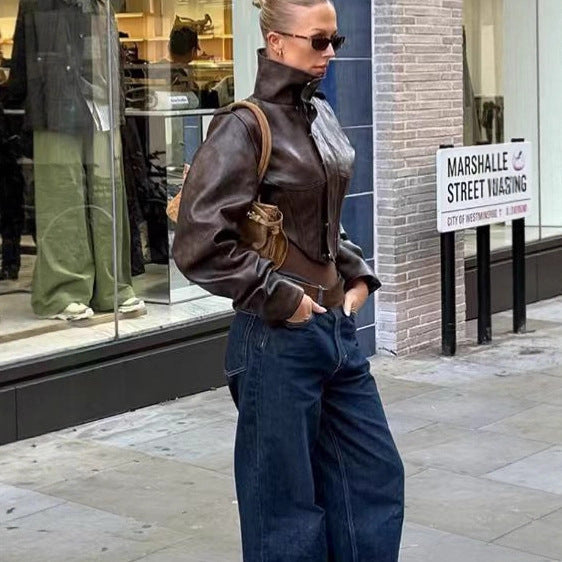 Women's short jacket made of faux leather with a high stand-up collar, shoulder flaps, and tailored silhouette Chichicherry