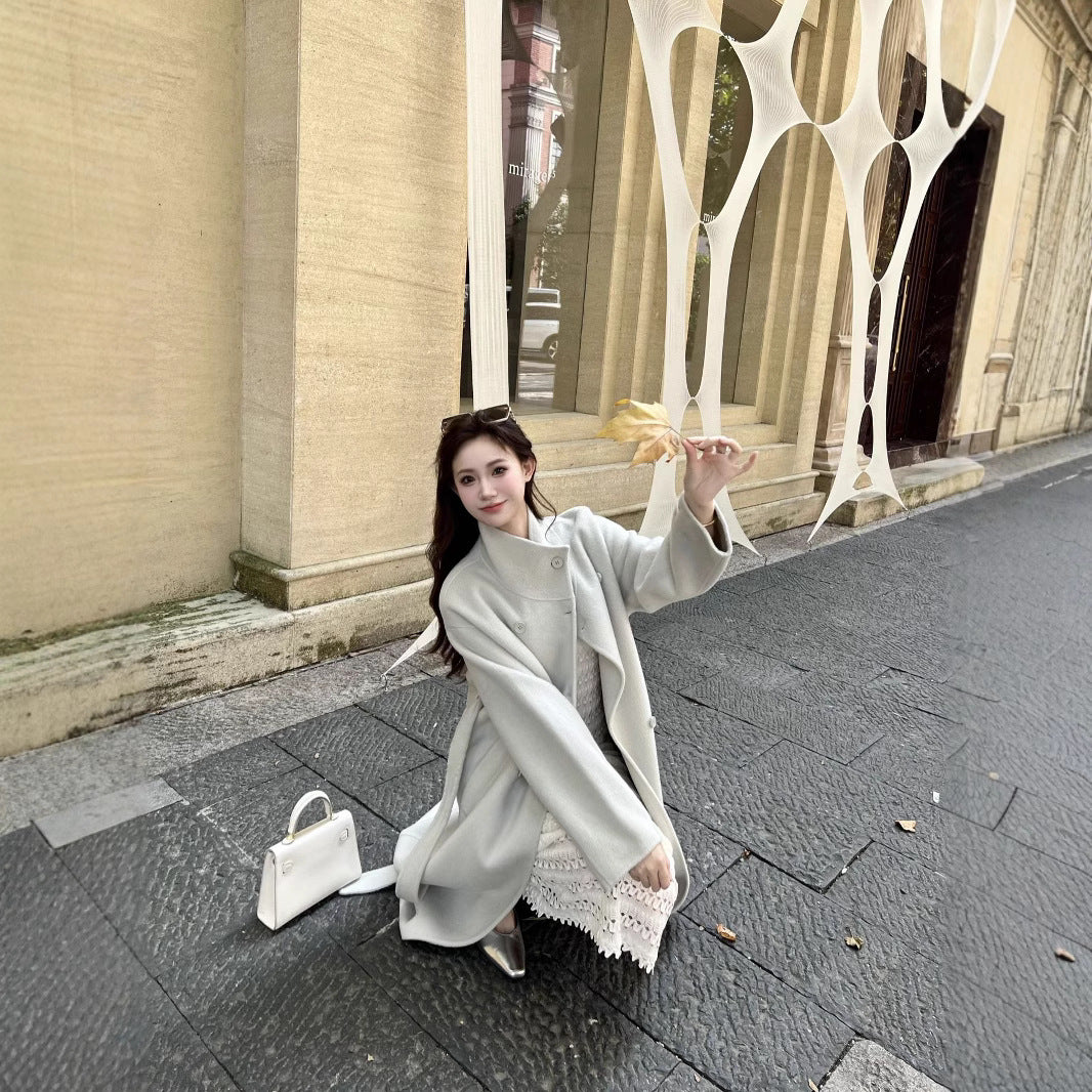 Women’s wool coat with double-breasted button placket, waist belt, and stand-up collar Chichicherry