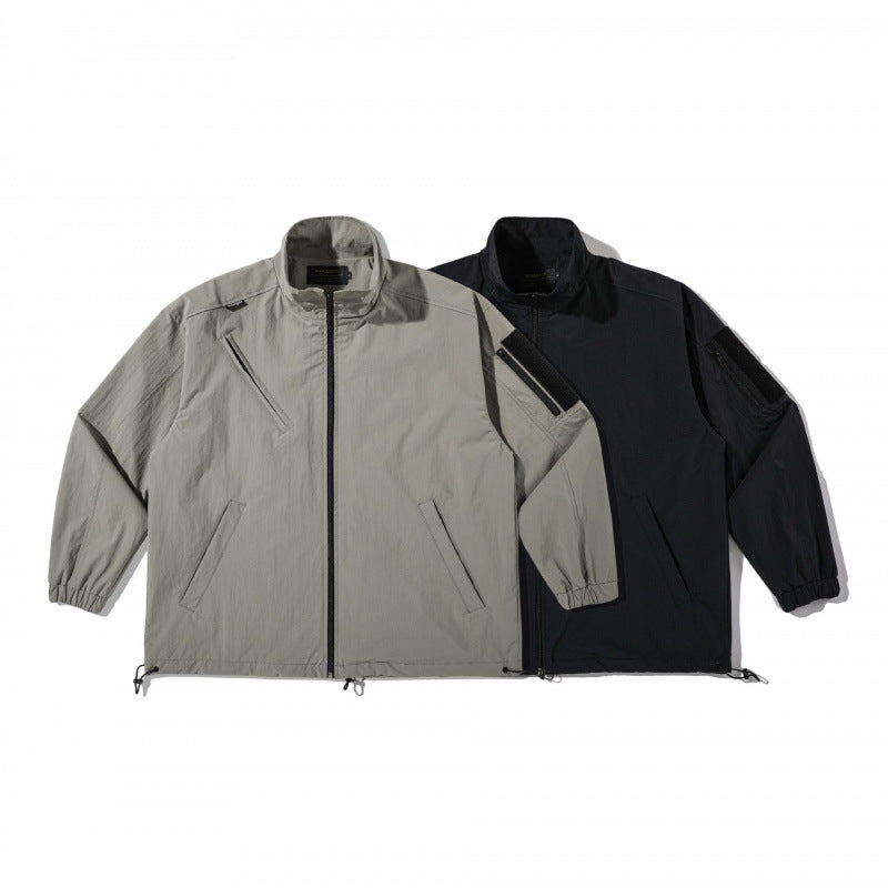 Unisex Lightweight Technical-Utility Jacket with Stand Collar, Zipper Pockets and Drawstring Hem Chichicherry