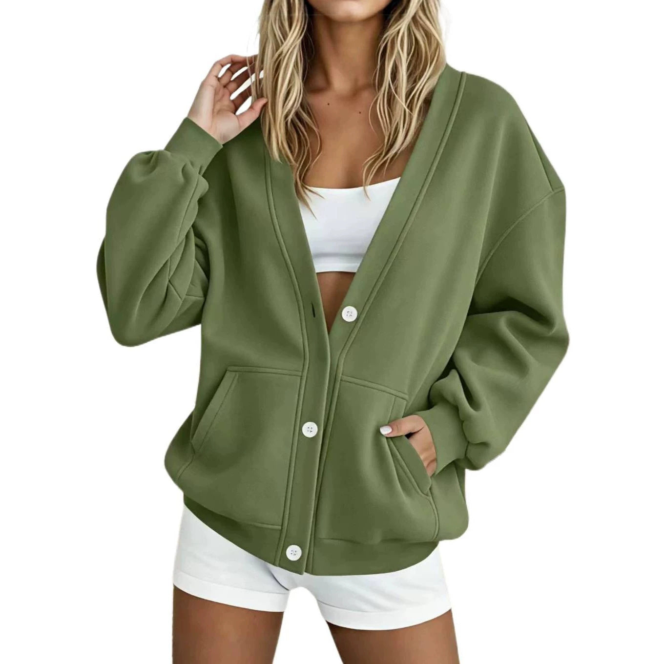 Women's oversized cardigan made of sweat fabric with V-neck, button placket, and kangaroo pockets.