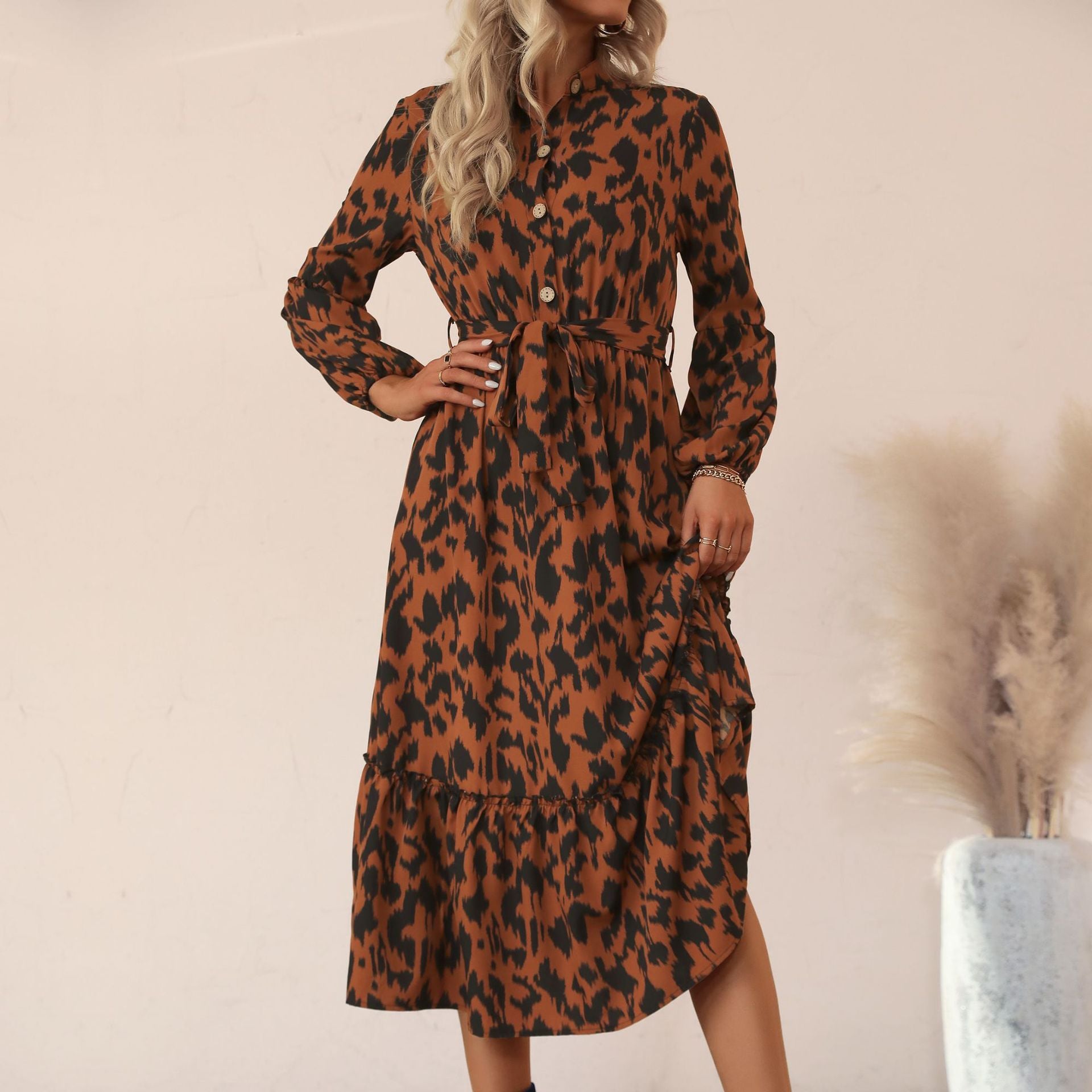 Women's viscose midi dress with leopard print, concealed button placket, waistband, and tiered ruffles.