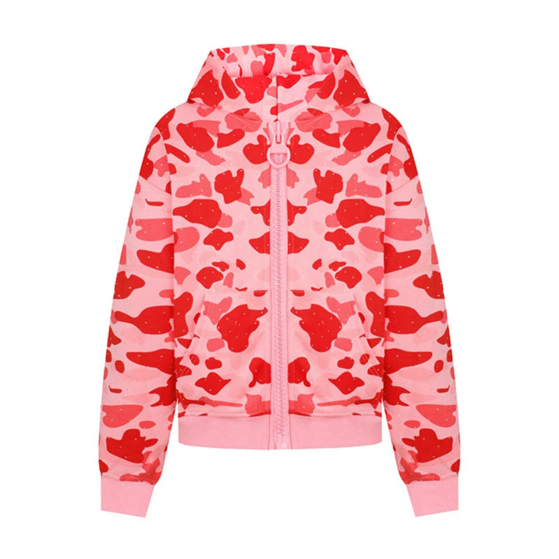Ladies' hooded jacket in camouflage print with a full-length zipper, kangaroo pocket, and ribbed cuffs.