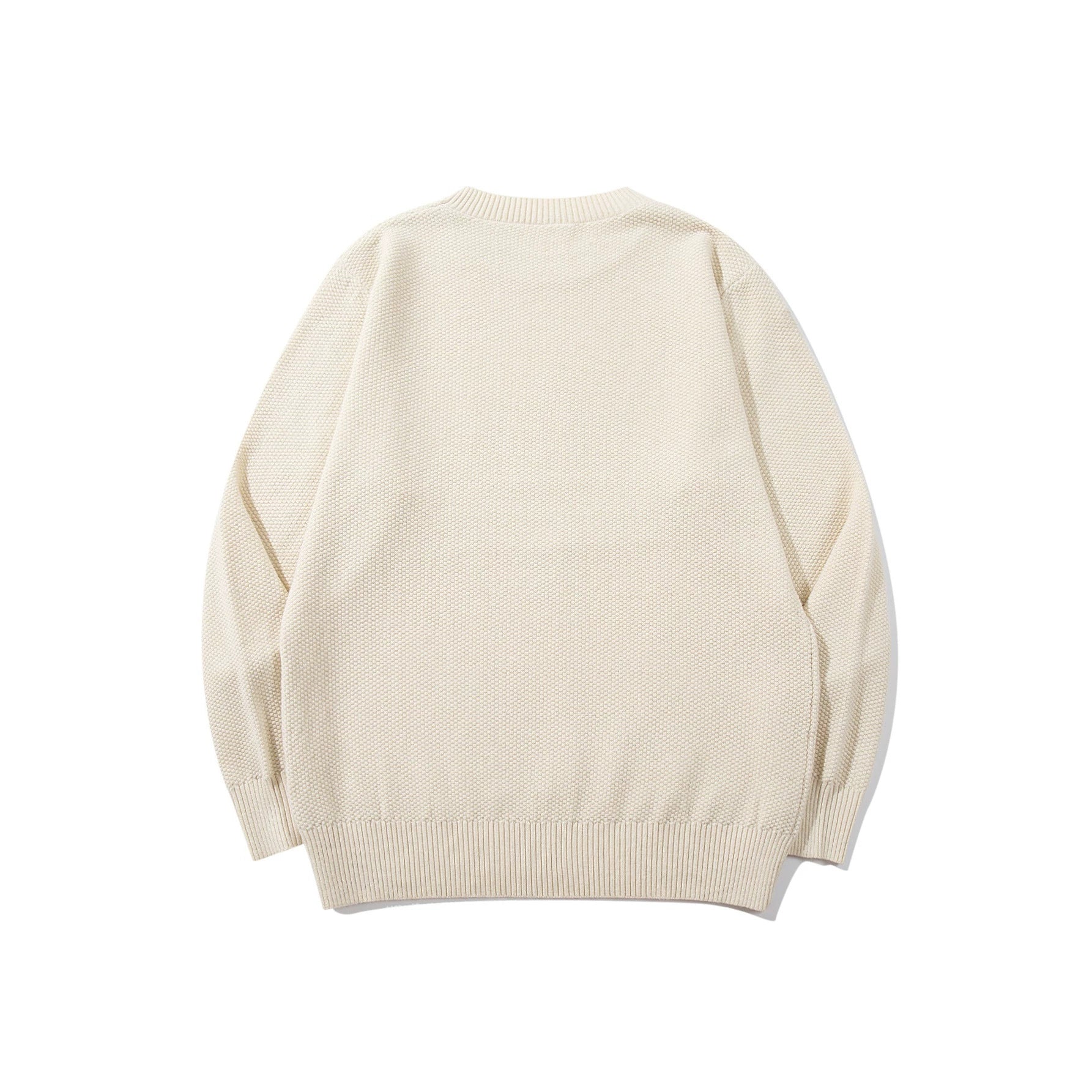 Unisex chunky knit round neck sweater with textured purl stitch and ribbed cuffs