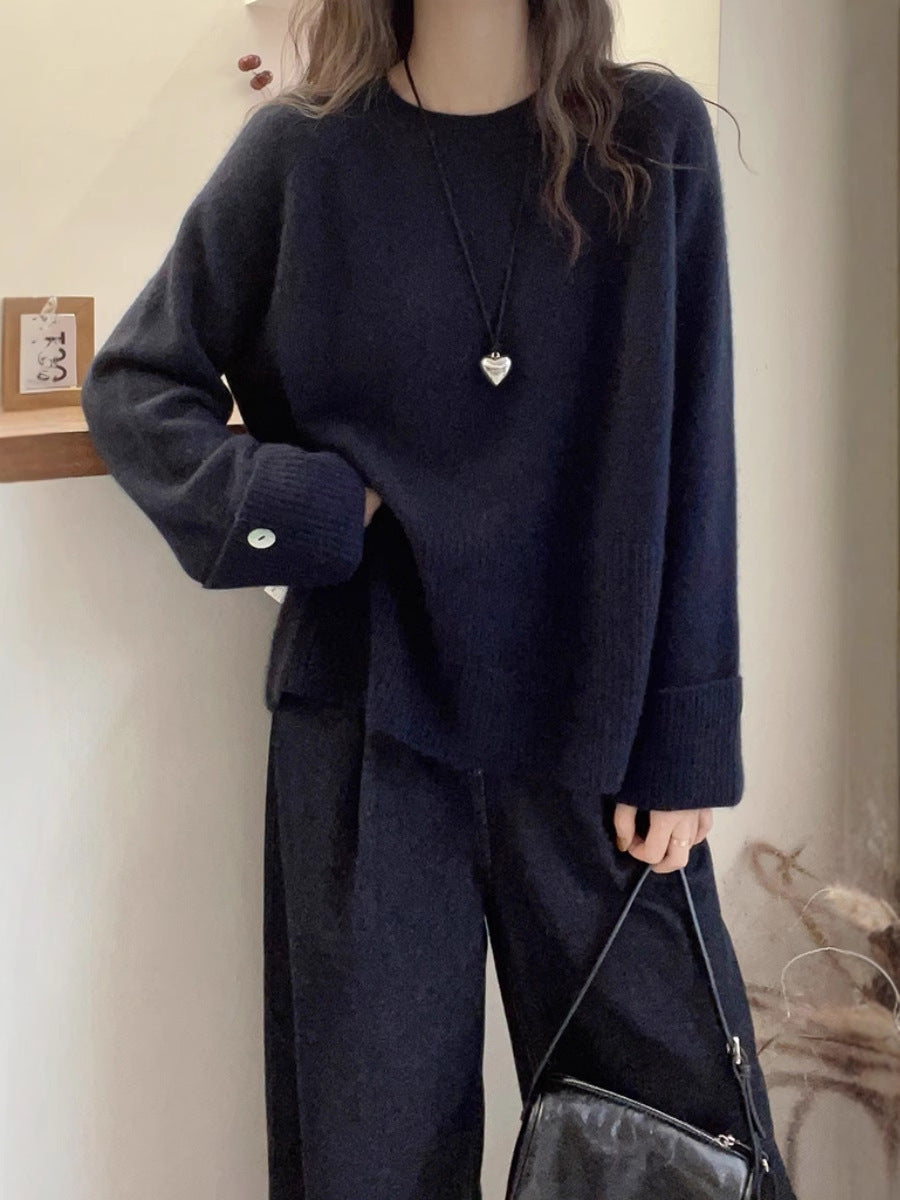 Women's oversized fine knit sweater with wide ribbed cuffs, extra wide sleeve endings, and decorative button Chichicherry