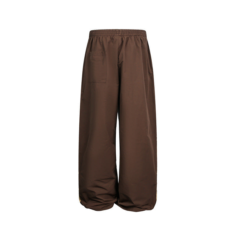 Women's wide satin training pants with elastic waistband and side contrast stripes Chichicherry
