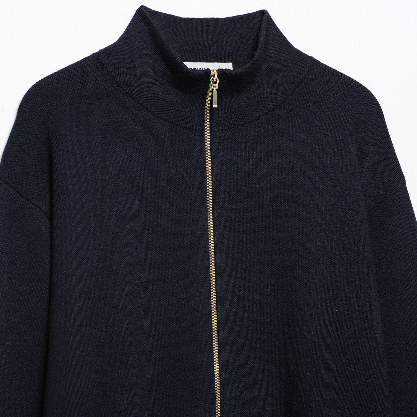 Women's cropped fine-knit cardigan with standing collar, full-length zipper, and fitted ribbed section.