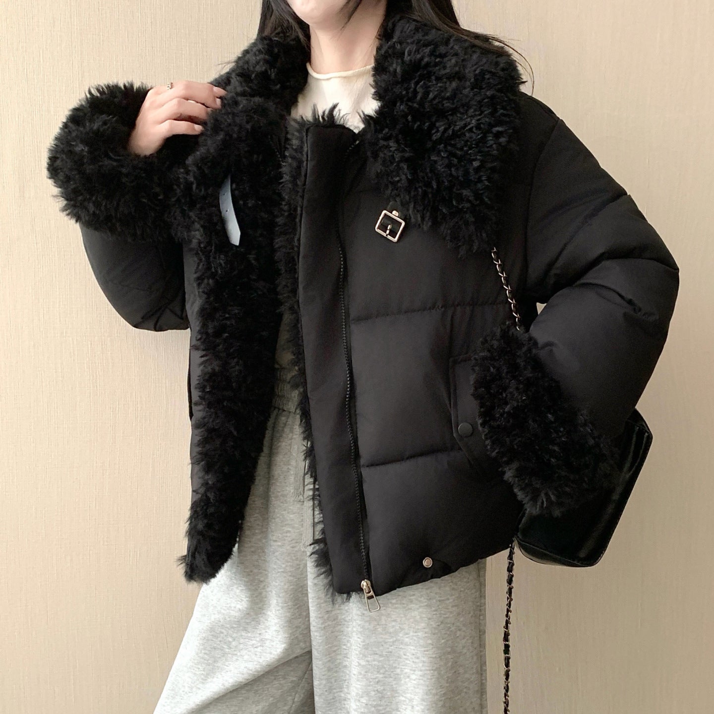 Women's short tailored puffer jacket with voluminous faux fur collar, buckle and zipper details Chichicherry