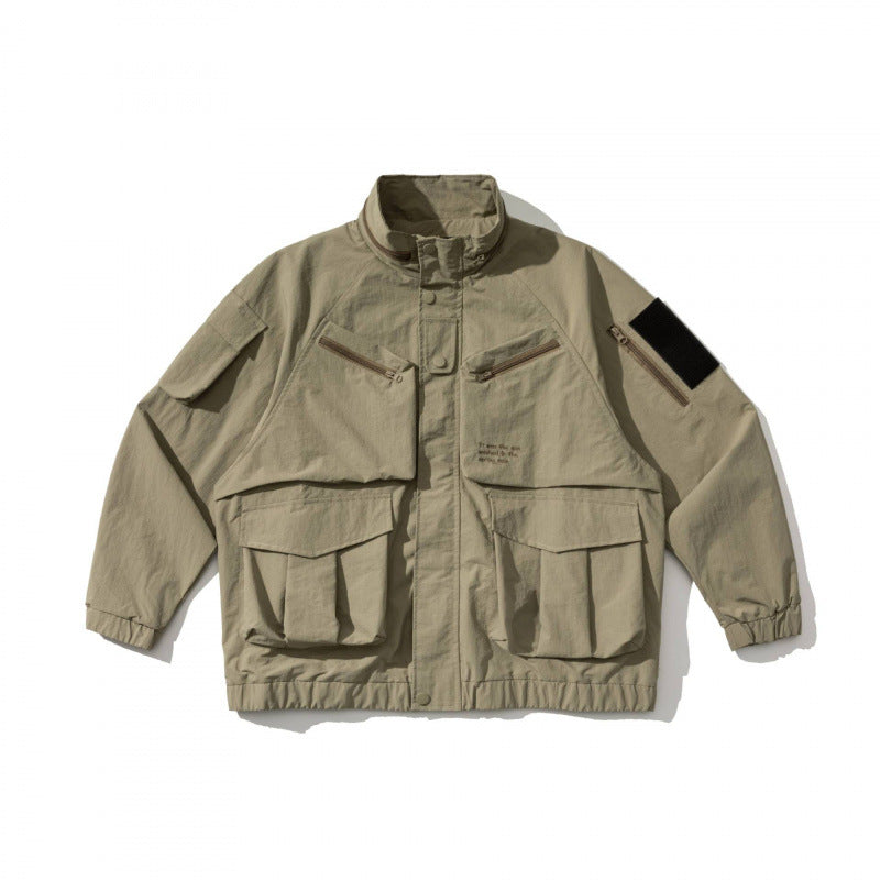 Unisex Oversize Utility Jacket with multifunctional pockets, high stand-up collar, and elastic hem Chichicherry